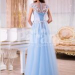 Women’s sky blue floor length evening gown with tulle skirt and floral bodice back side view