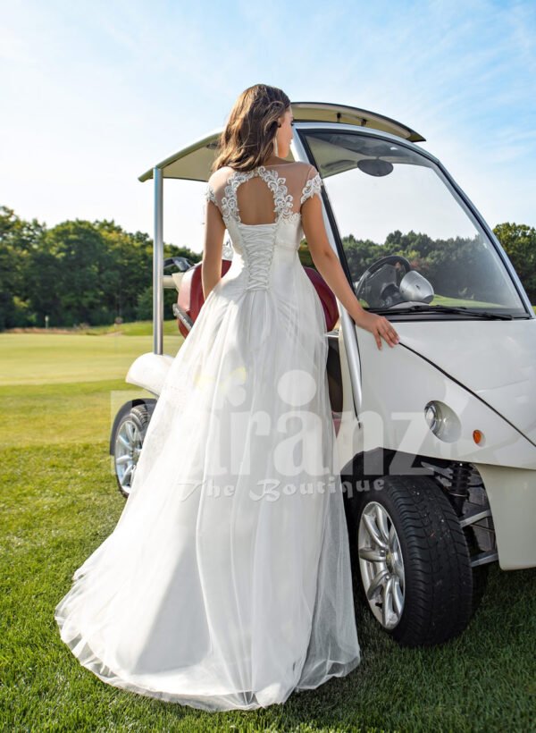 Women’s sleeveless elegant white flared high volume tulle wedding gown Back side view