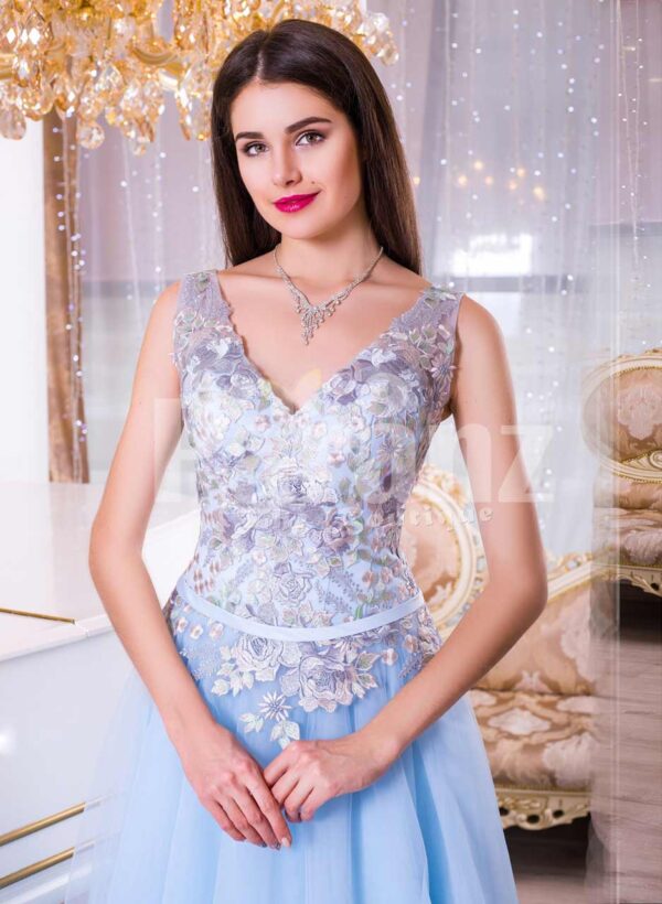 Women’s sleeveless evening gown with floor length tulle skirt and flower appliquéd bodice