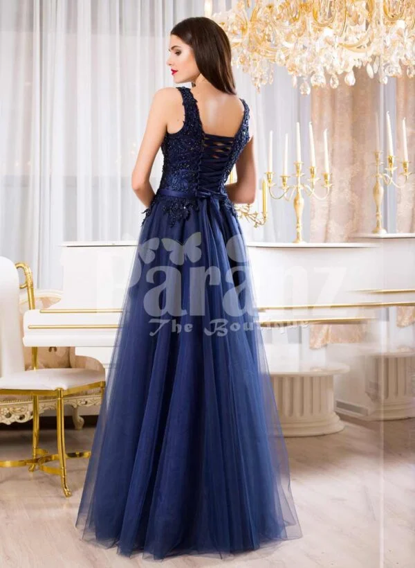 Women’s sleeveless navy floor length gown with rich rhinestone studded bodice back side view