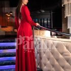 Women’s soft and smooth deep red evening gown with side slit skirt and full sleeves back side view