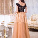 Women’s stunning evening gown with lacy black bodice and long peach tulle skirt back side view