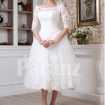 Women’s tea length white lacy bodice and tulle skirt wedding gown