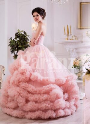 Women’s unique elegant evening gown with long tulle skirt with ruffle cloud hem in pink side view