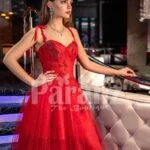 Women’s vibrant red floor length tulle frill evening gown with stylish sleeveless bodice