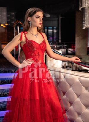 Women’s vibrant red floor length tulle frill evening gown with stylish sleeveless bodice
