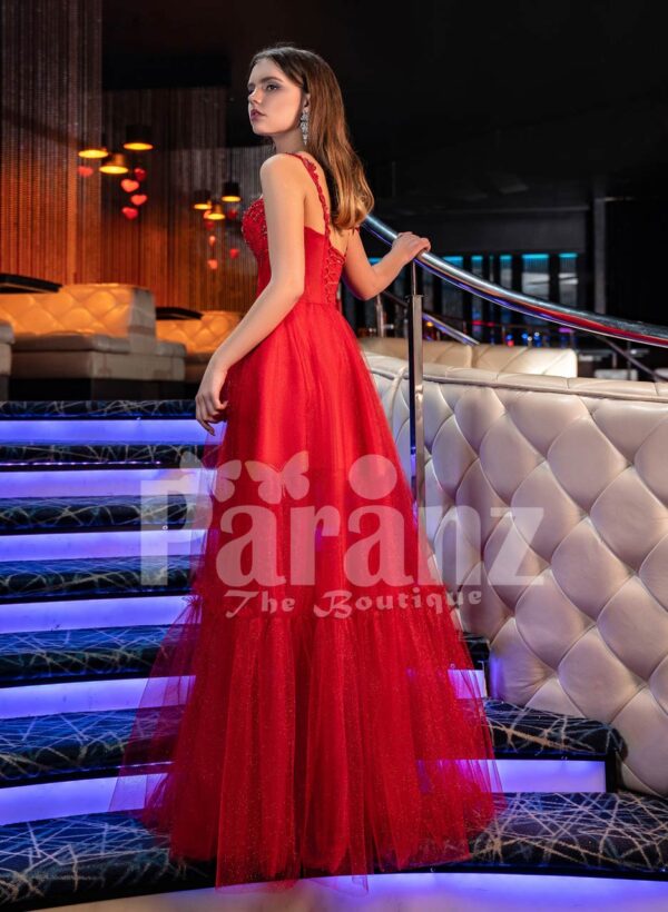 Women’s vibrant red floor length tulle frill evening gown with stylish sleeveless bodice back side view