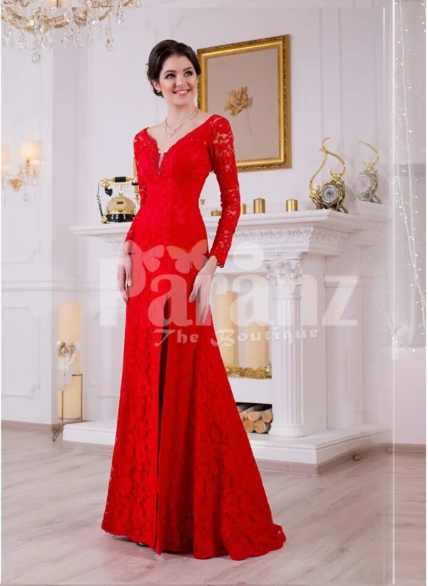 Women’s vibrant red side slit full sleeve glam evening gown with all over lace work