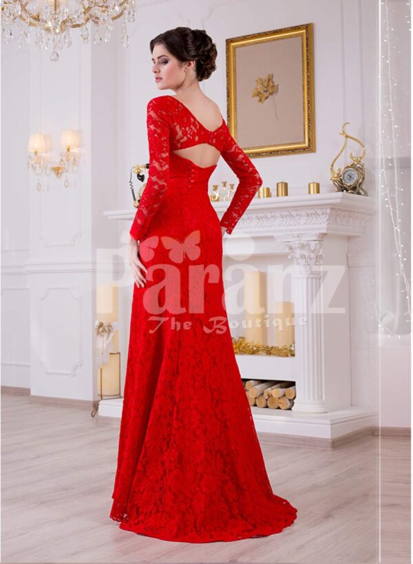 Women’s vibrant red side slit full sleeve glam evening gown with all over lace work back side view