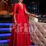 Women’s vibrant red side slit tulle skirt gown with long frilly sleeves