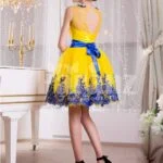 Bright yellow small evening gown with short tulle skirt and rich blue lace work back side view