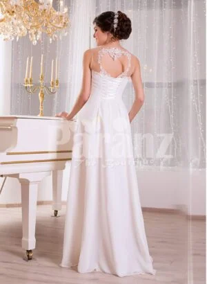 Elegant pearl white sleeveless evening gown with long tulle skirt and lace appliquéd bodice back side view