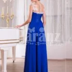 Women’s blue floor length sleek tulle skirt evening gown with white floral appliquéd bodice Side view