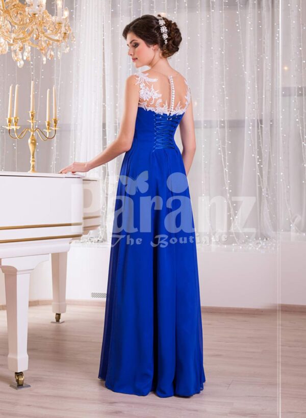 Women’s blue floor length sleek tulle skirt evening gown with white floral appliquéd bodice Side view