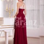 Women’s deep maroon floor length sleek tulle skirt dress with white flower appliquéd bodice side view