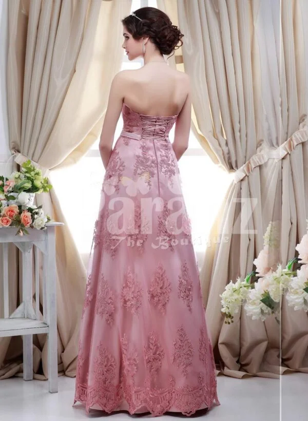 Women’s metallic pink off-shoulder evening party gown with floor length lace work skirt back side view