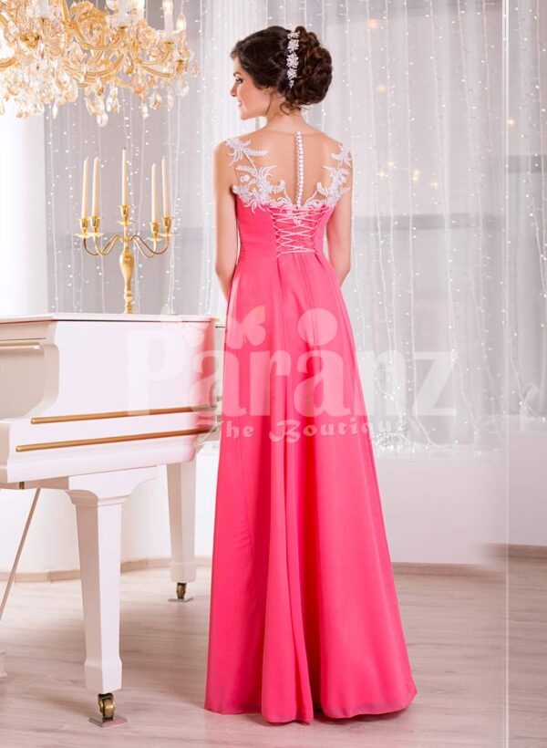 Women’s pink evening gown with white floral appliquéd bodice and sleek tulle skirt back side view