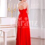 Women’s vibrant red sleeveless evening gown with sleek and long floor length tulle skirt side view