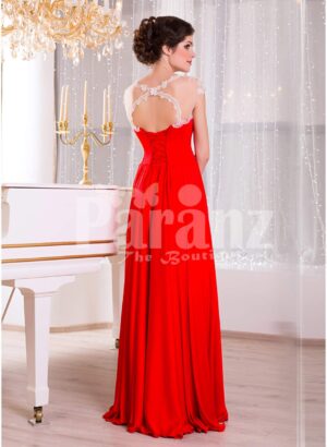 Women’s vibrant red sleeveless evening gown with sleek and long floor length tulle skirt side view