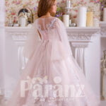 A white and long formal dress meant for little girls back side view